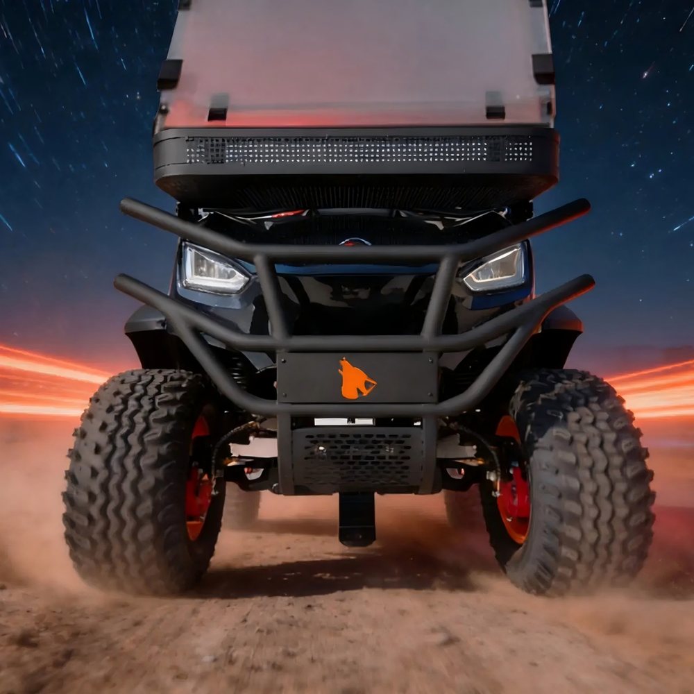 Front view of a Wolverine cart with brush guard and all-terrain tires